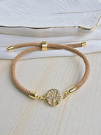 Pulsera cordón con dije en rodio y circones